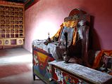 16 Inside Chuku Nyenri Gompa Kangyur And Head Monk Chair With Bell, Drum, And Peacock Teapot On Mount Kailash Outer Kora The Chuku (Nyenri) Gompa has the 108 volumes of the Kangyur and the chair for the head monk with some common Tibetan Buddhist ritual elements like bell, damaru drum, and peacock teapot.